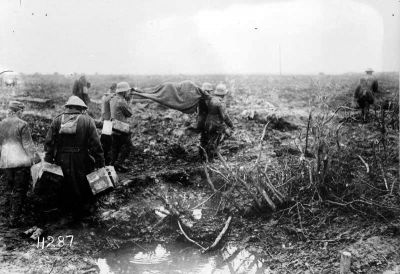 German prisoners carry a wounded man at Passchendaele, 4 October 1917